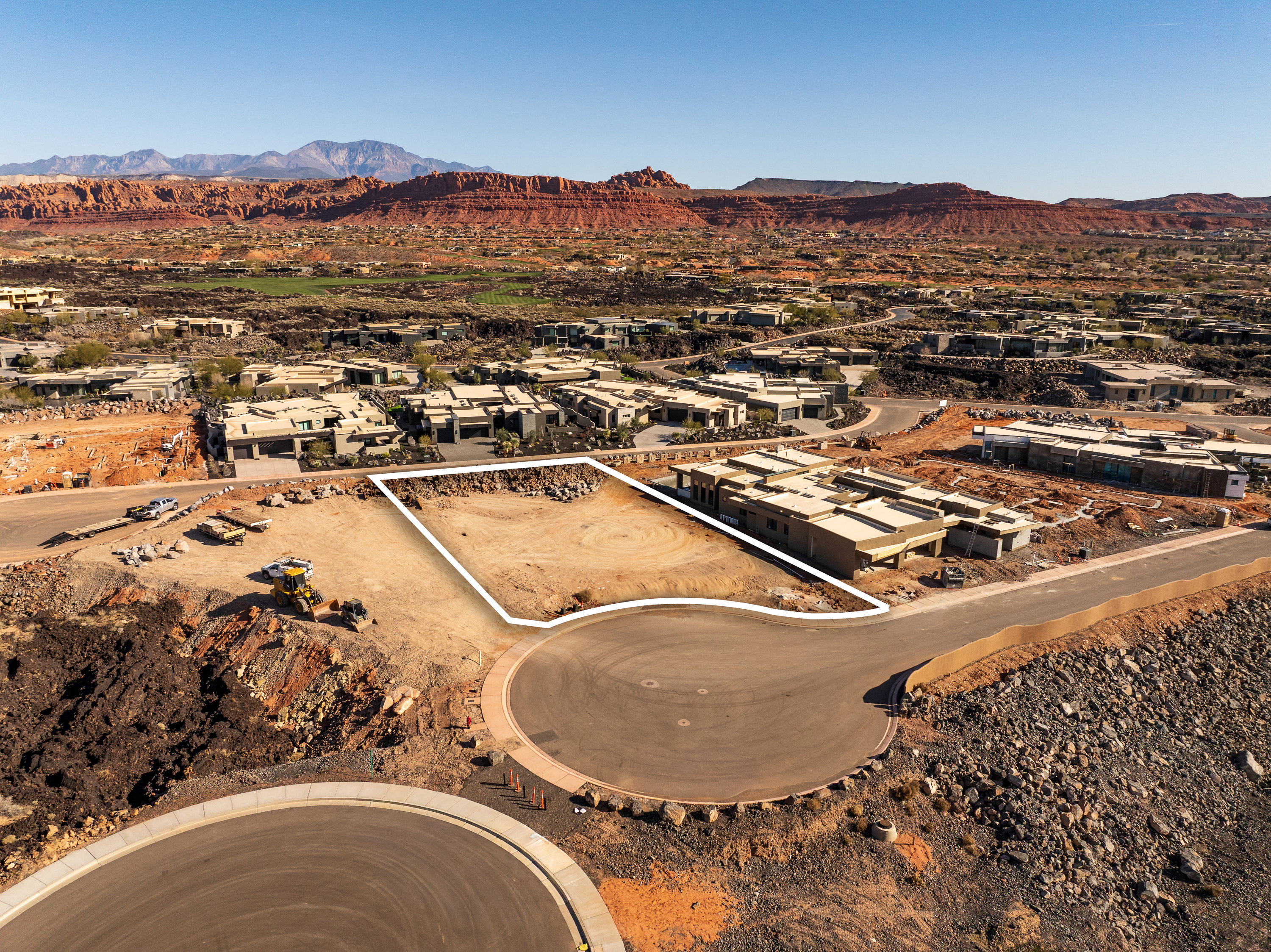 Aerial perspective of suburban area featuring a mountain backdrop