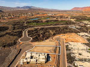 Aerial view of residential area featuring a water and mountain view and a local golf course
