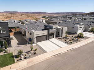 Modern home with a residential view, driveway, a garage, and stucco siding