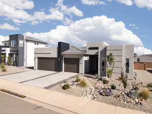 Modern home with stucco siding, driveway, and a garage