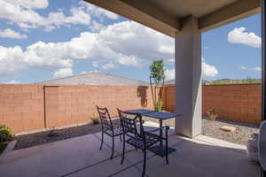 Fenced backyard with outdoor dining space and a patio