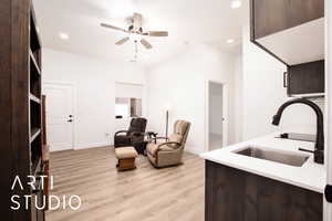 Living room with light wood-style floors, recessed lighting, and ceiling fan