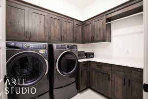 Laundry area with separate washer and dryer and cabinet space