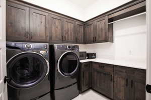 Laundry room with washing machine and clothes dryer and cabinet space