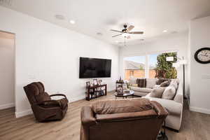 Living room featuring recessed lighting, a ceiling fan, and light wood-type flooring