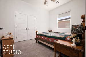 Bedroom with carpet flooring, a closet, and a ceiling fan