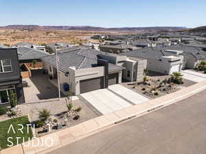 Modern home with a residential view, a garage, concrete driveway, and stucco siding