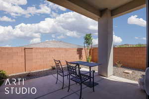 Fenced backyard featuring outdoor dining area and a patio