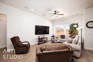 Living area with recessed lighting, a ceiling fan, and wood finished floors