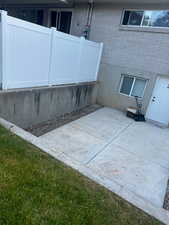 View of side of home featuring a patio and brick siding