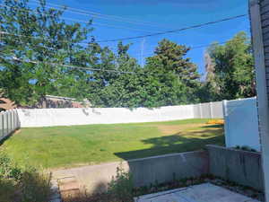 Fenced backyard with a patio area