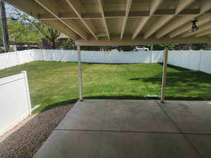 Fenced backyard with a patio