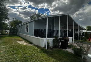View of home's exterior with a yard