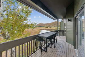 Deck with a water and mountain view