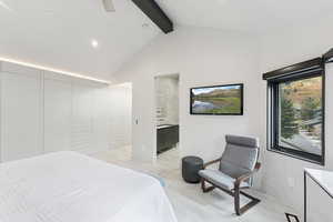 Bedroom with beam ceiling, high vaulted ceiling, ceiling fan, recessed lighting, and ensuite bathroom