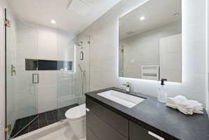 Bathroom featuring vanity and a shower stall