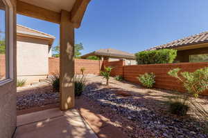 Fenced backyard with a patio area