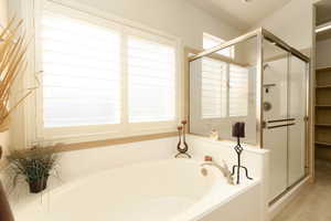 Bathroom with a stall shower and a bath