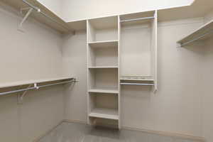 Walk in closet featuring light carpet