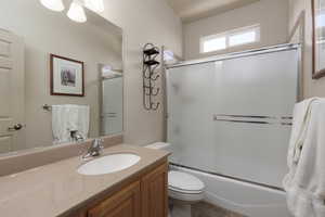 Bathroom with vanity and shower / bath combination with glass door