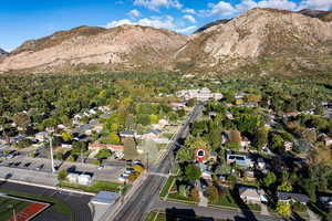 Aerial overview of property's location featuring a mountain backdrop and nearby suburban area