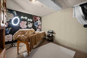 Bedroom featuring carpet floors and a paneled ceiling