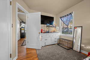 Bedroom featuring wood finished floors and baseboards
