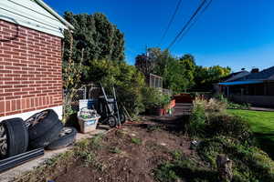 View of yard with a vegetable garden and a sunroom
