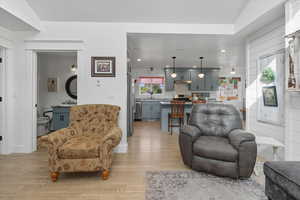 Living area featuring light wood-style flooring and recessed lighting