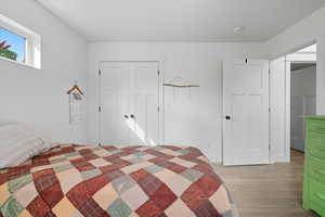 Bedroom with light wood-style floors and a closet
