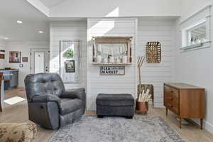 Living room featuring wood finished floors, recessed lighting, and wooden walls