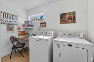 Laundry area featuring washer and clothes dryer and light wood-style floors