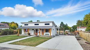 Modern farmhouse with covered porch, a standing seam roof, a metal roof, and driveway