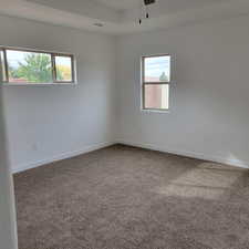 Empty room featuring carpet and a ceiling fan