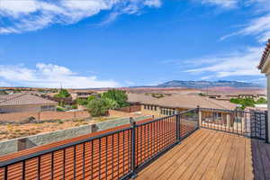 Deck with a residential view and a mountain view