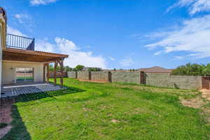 Fenced backyard with a patio and a pergola
