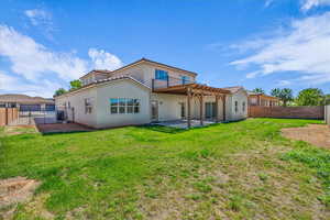 Back of property featuring a fenced backyard, a patio area, stucco siding, and a pergola
