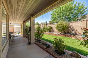 Porch with a fenced backyard and outdoor dining area