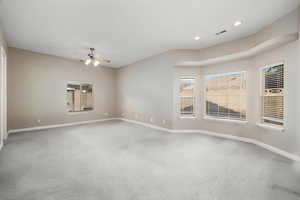 Empty room with light colored carpet, recessed lighting, and a ceiling fan