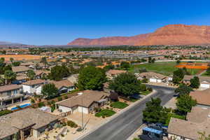 Aerial perspective of suburban area featuring a mountain backdrop