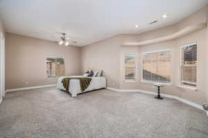 Carpeted bedroom featuring a ceiling fan and recessed lighting
