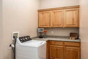 Laundry area with washer / dryer and cabinet space