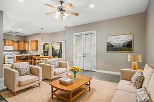 Living room featuring ceiling fan, french doors, and recessed lighting