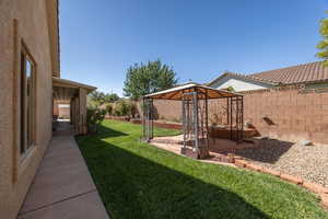 Fenced backyard with a patio area