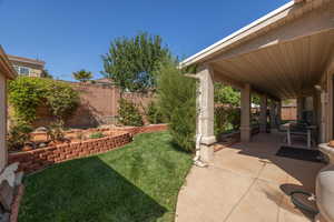 Fenced backyard featuring a patio