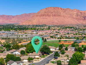 Aerial perspective of suburban area with a mountainous background