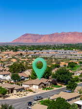 Aerial perspective of suburban area with a mountainous background