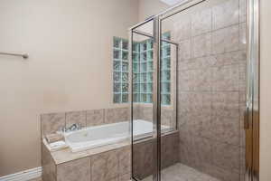 Full bath featuring a shower stall and a bath