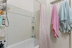 Full bath featuring shower / bathtub combination with curtain