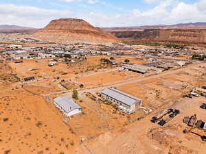 Aerial overview of property's location featuring mountains and nearby suburban area